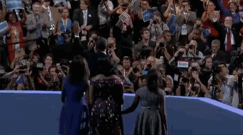 gif of Michelle, Malia, and Sasha greeting Barack onstage after his speech