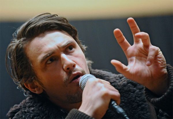 image of James Franco gesturing solemnly while speaking into a microphone
