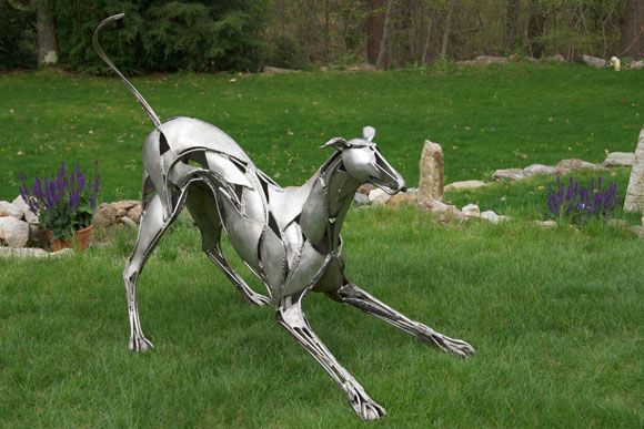image of a stainless steel sculpture of a greyhound play-bowing