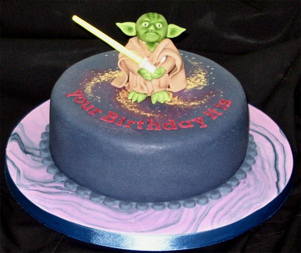 image of a birthday cake featuring a really shitty rendition of Yoda and text reading 'your birthday it is'