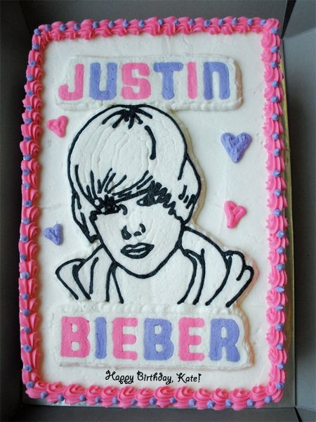 image of a birthday cake featuring a black and white drawing of Justin Bieber, his name in giant purple and pink letters, and 'Happy Birthday, Kate!' in small black lettering