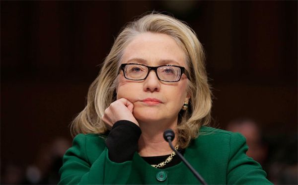 image of Clinton with her chin resting in her hand, looking bored