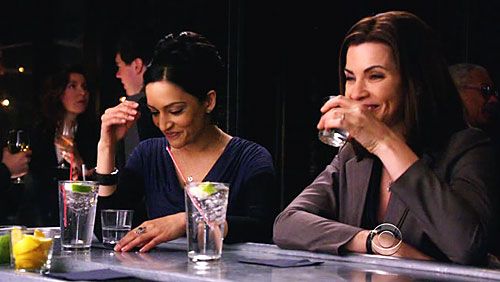 image of Kalinda (Archie Panjabi, a thin, middle-aged Indian woman) and Alicia (Julianna Margulies, a thin, middle-aged white woman with dark hair) sitting at a bar laughing and drinking, in The Good Wife