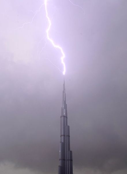 image of a lightning bolt striking a spire in front of a purple stormy sky