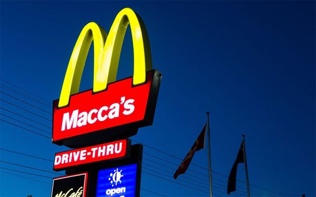 image of the iconic McDonald's golden arches beneath which it typically reads 'McDonald's,' but here reads instead 'Macca's'.