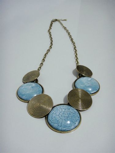 image of a necklace with gold and turquoise spheres in front and an adjustable chain in back