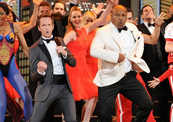 image of actor Neil Patrick Harris and former boxer Mike Tyson dancing onstage with a bunch of back-up dancers during The Tonys opening number