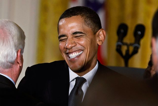 image of President Barack Obama grinning with his eyes closed and his whole face wrinkled up