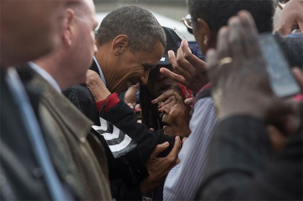 image of President Obama having a private moment with an older woman in a crowd at a campaign event