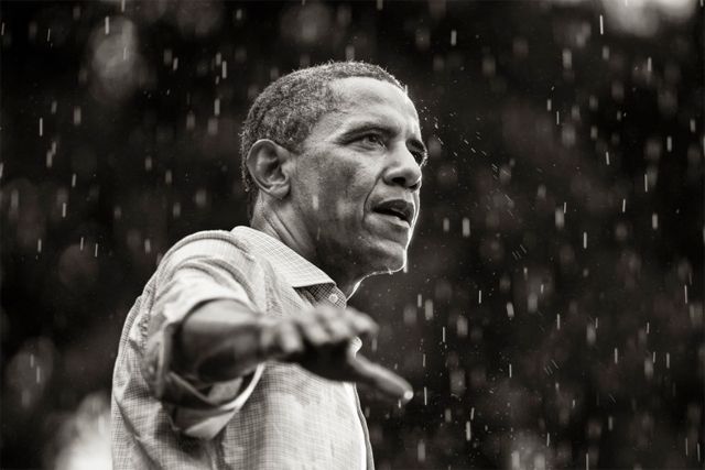 image of President Obama delivering an address in the rain, on the campaign trail last year