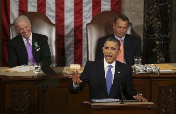 image from one of President Obama's State of the Union addresses; he is standing and speaking; behind him, Vice President Biden is laughing and Speaker Boeher is scowling