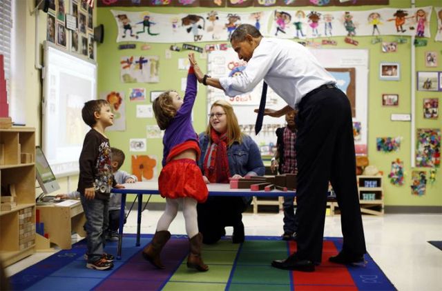 image of President Obama high-fiving a little girl in a classroom