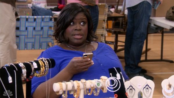 image of Donna (Retta) holding her mobile phone in her hand and making a fuckya expression