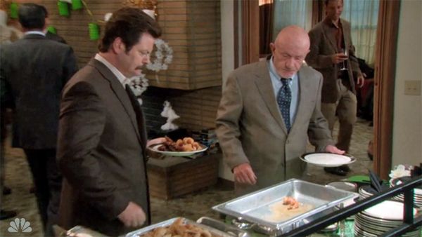 image of Ron Swanson and Ben's Dad approaching a buffet tray with only one bacon-wrapped shrimp left