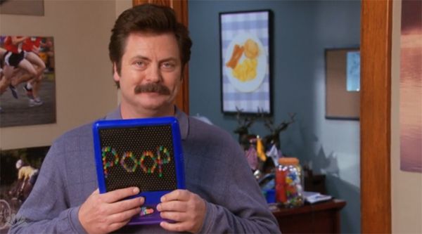 image of Ron Swanson (Nick Offerman) holding up a Lite-Brite that reads POOP