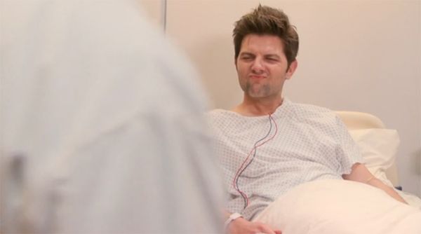 image of Ben (Adam Scott) lying in a hospital bed making a stoned face while hopped up on morphine