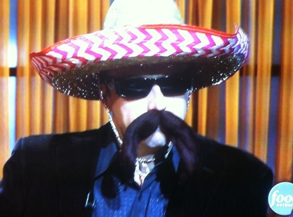 Chef Marc Murphy, a white man, wearing a sombrero, sunglasses, and fake black mustache
