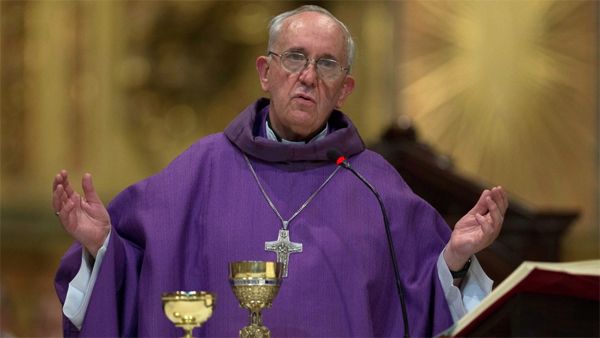 an image of the newly-elected Pope Francis, an older man who appears to be white, presiding over mass in a purple vestment