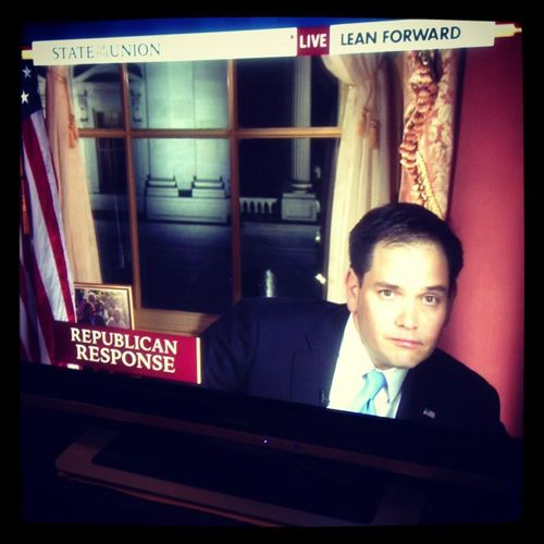 image of a television on which has been captured the awkward moment in which Senator Marco Rubio lunged offscreen for a bottle of water during last night's State of the Union rebuttal