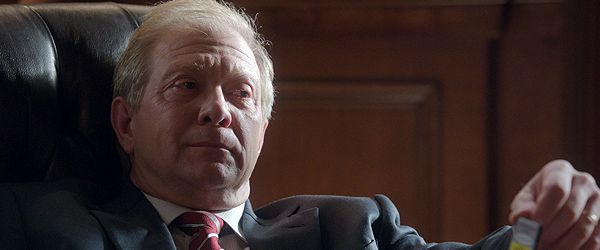 image of Cyrus Beene sitting at his desk, in Scandal