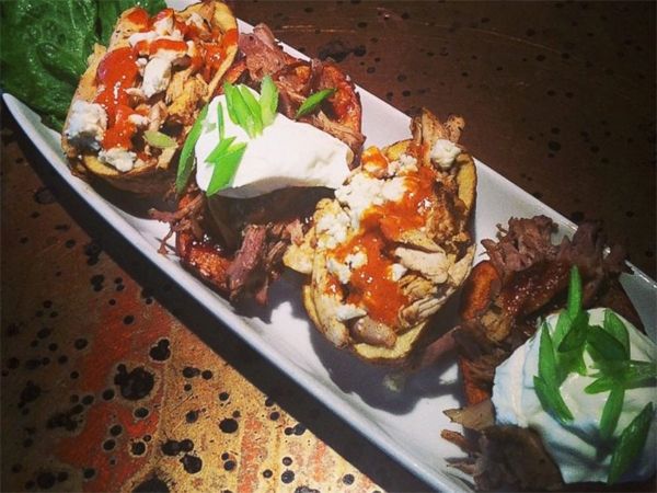 image of potato skins on a serving platter loaded with toppings