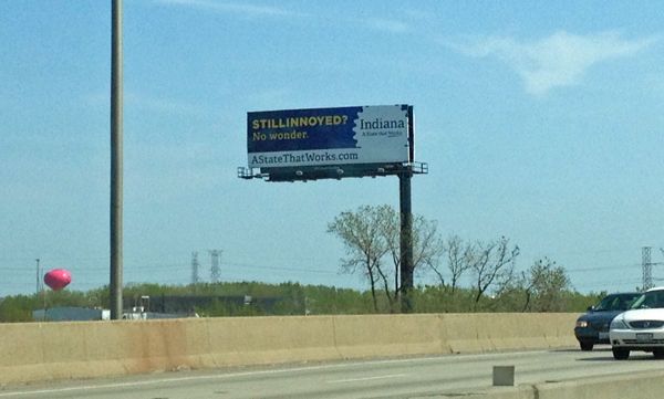 image of a billboard reading: 'STILLINNOYED? No wonder. Indiana: A state that works.'