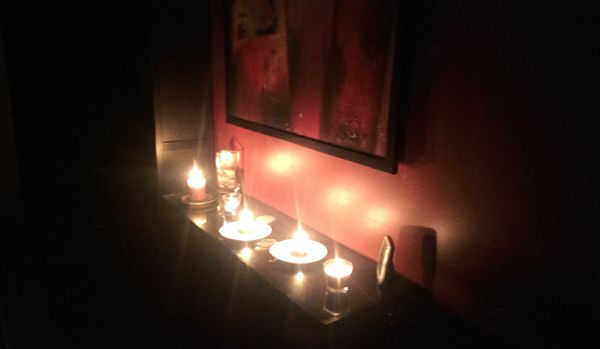 image of candles lit in a dark Shakes Manor
