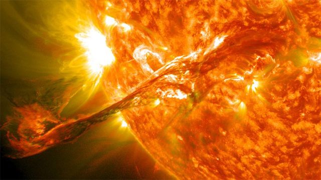 image of an arc of plasma shooting off the surface of the sun