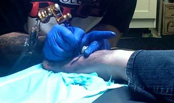 image of my foot being tattooed