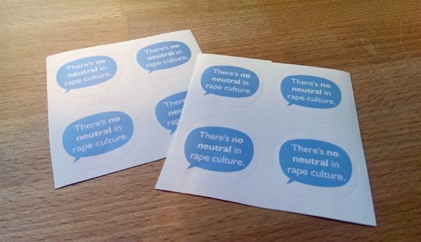 images of a sheet of stickers; each sticker is a blue dialogue bubble with the words 'there's no neutral in rape culture' inside