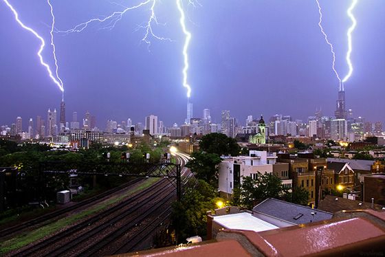 image of a triple lightning strike in Chicago hitting the Hancock Building, Trump Tower, and the Sears Tower all at the same time