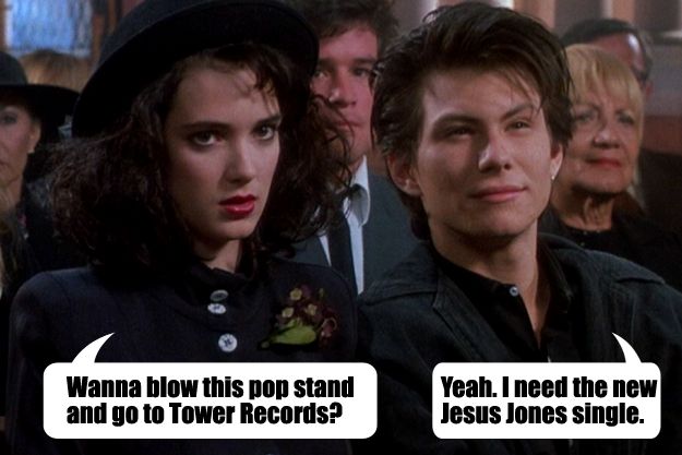 screen shot of Winona Ryder and Christian Slater in the film 'Heathers' sitting next to one another in an auditorium; I've added talk bubbles making Ryder say 'Wanna blow this pop stand and go to Tower Records?' and Slater reply 'Yeah. I need the new Jesus Jones single.'