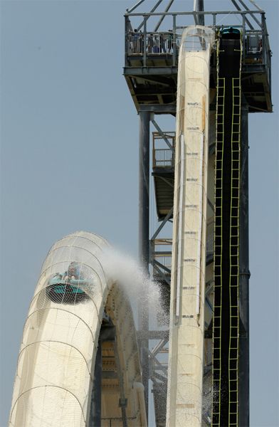 image of a verrrrry tall water slide, which plummets almost straight down, then goes upwards and over another curve