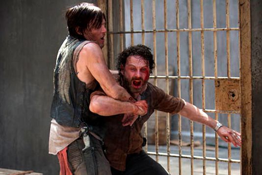 image of Grimes rage-screaming while Daryl holds him back
