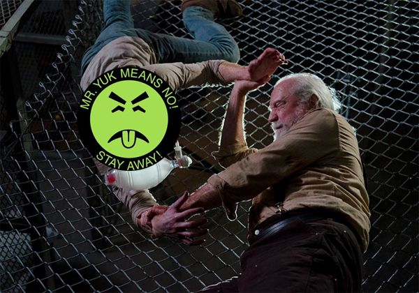 Hershel wrestles with a zombie, whose face has been covered by a Mr. Yuk sticker