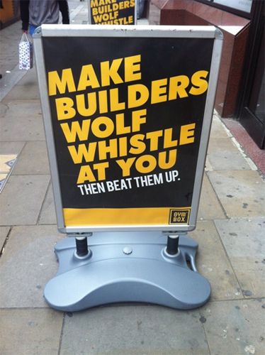 image of a sidewalk-stand advertisement reading: 'Make builders wolf whistle at you. Then beat them up. Gymbox.'