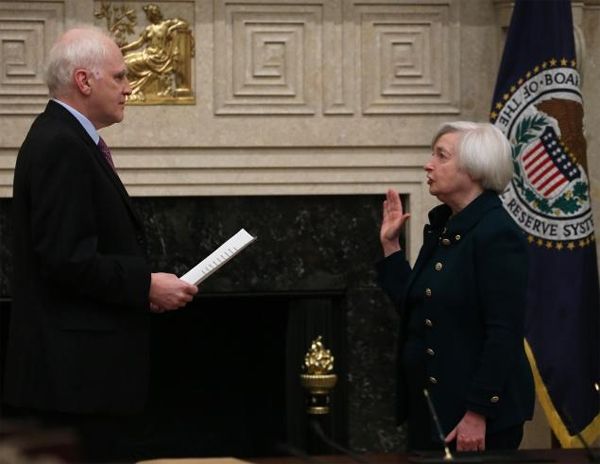 image of Janet Yellen, a petite older white woman, being sworn in by an older white man in a black judge's robe