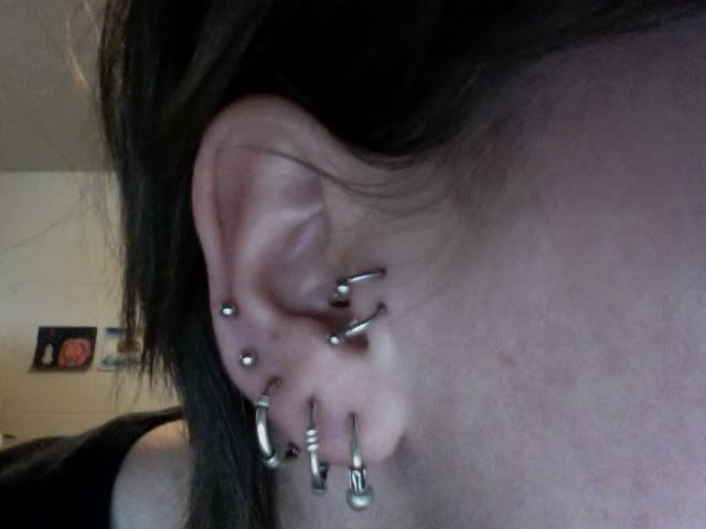 I was thinking three helix piercings closer to the top, but I don't know 