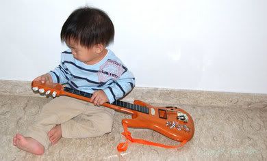 Elijah tuning his guitar