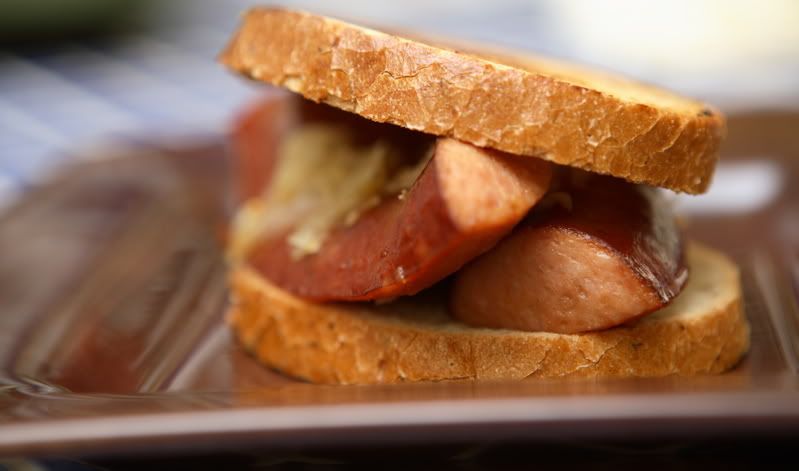  the bread with mustard, then topped it with the kielbasa and sauerkraut.