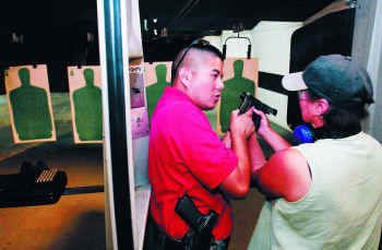 D.V. Ing, a concealed handgun license instructor, gave some pointers to state Rep. Vicki Truitt during a recent class in Fort Worth.