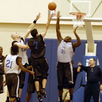 J.J. Redick of the Orlando Magic attempts a layup over the outstretched arms of teammate Adonal Foyle during an intrasquad scrimmage at RDV Sportsplex in Maitland, FL, on October 4th, 2007.