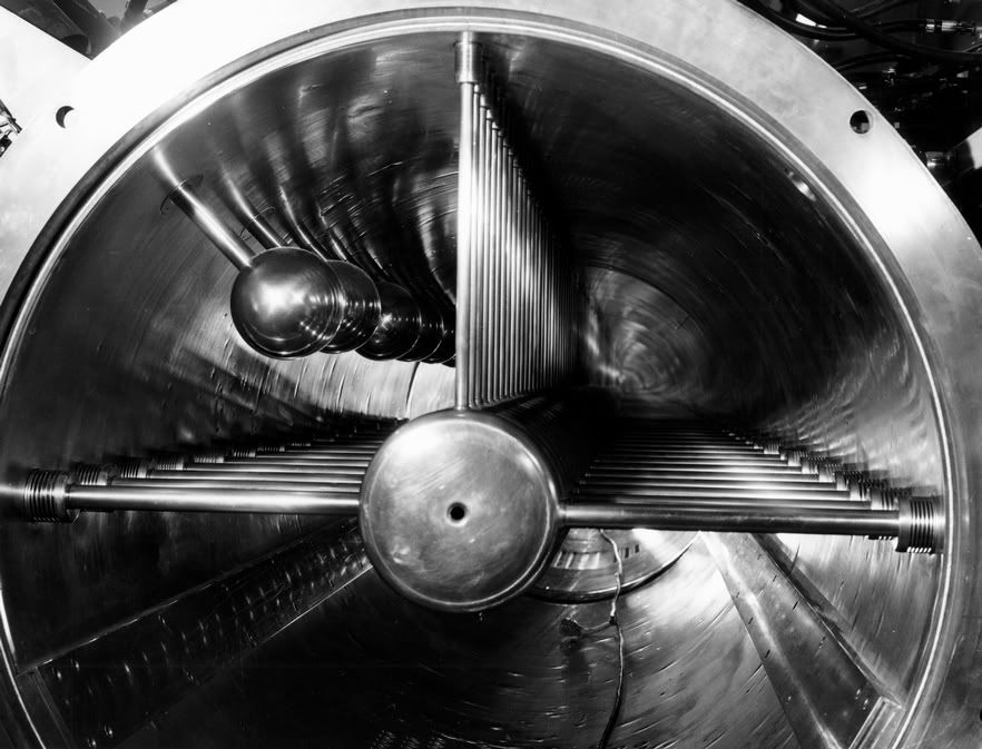 A view down the Zero Gradient Synchrotron's 110-foot linear accelerator. (Archival Photographic Files, apf digital item number apf2-00487, Special Collections Research Center, University of Chicago Library) A view down the Zero Gradient Synchrotron's 110-foot linear accelerator. (Archival Photographic Files, apf digital item number apf2-00487, Special Collections Research Center, University of Chicago Library)