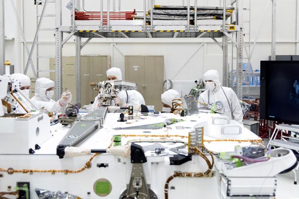 Inside the Spacecraft Assembly Facility at NASA's Jet Propulsion Laboratory near Pasadena, California, engineers install the Mars 2020 rover's high-gain antenna...on April 19, 2019.