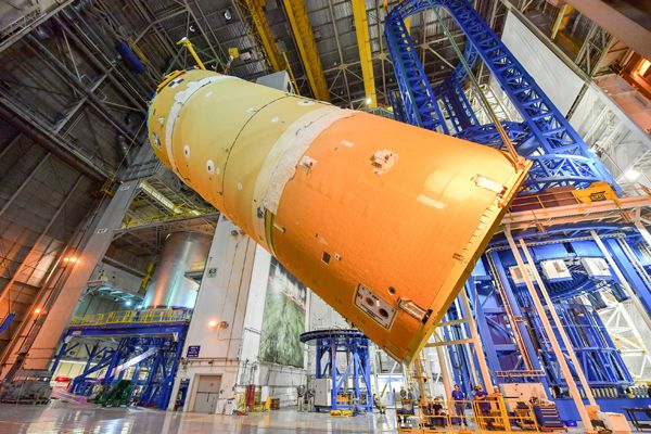 The forward join for the Space Launch System (SLS) rocket is about to be lowered into horizontal position at NASA's Michoud Assembly Faciliy in New Orleans, Louisiana...in preparation for its mate to the SLS' liquid hydrogen tank.