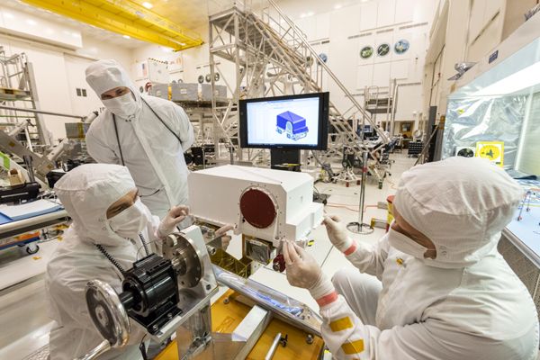 Engineers work on the Mastcam-Z camera, located on the Mars 2020 rover's remote sensing mast, at NASA's Jet Propulsion Laboratory near Pasadena, California...on May 23, 2019.