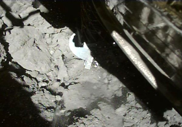 A snapshot of Hayabusa2's sampler horn making contact with the surface of asteroid Ryugu...as seen from the spacecraft's small monitor camera on July 11, 2019.