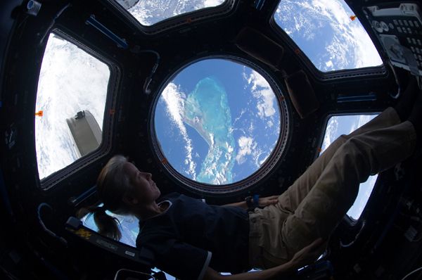 NASA astronaut Shannon Walker gazes out of the International Space Station's Cupola at a Caribbean island over 200 miles beneath her...on November 25, 2010.
