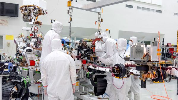 Engineers install the robotic arm on the Mars 2020 rover at NASA's Jet Propulsion Laboratory near Pasadena, California...on June 21, 2019.