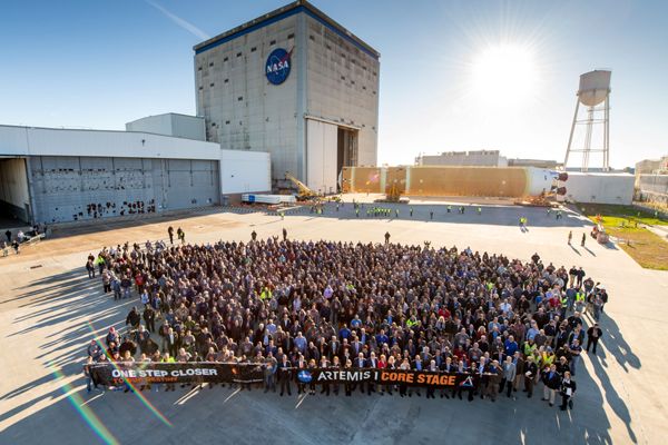 Boeing and Aerojet Rocketdyne personnel gather for a group photo in front of the Space Launch System's first core stage booster at NASA's Michoud Assembly Facility in Louisiana...on January 8, 2020.